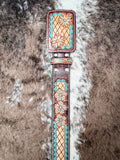 Decorative leather belt with intricate patterns on a textured surface