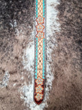 Leather belt with floral patterns on a textured surface