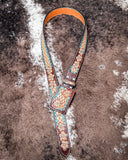 Leather belt with floral patterns on a textured surface