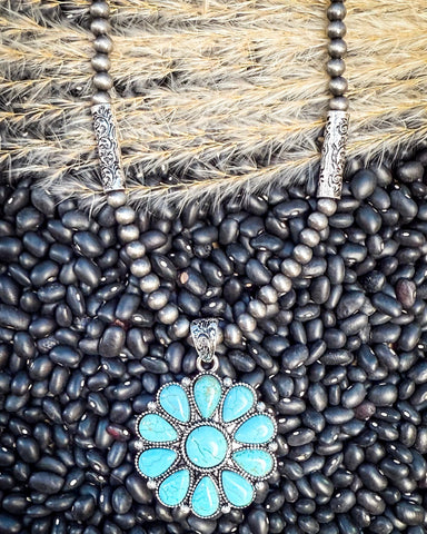 The Lola Flower Pendant Fashion Necklace on beans and wheat.