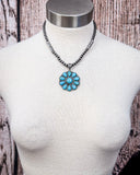 The Lola Flower Pendant Fashion Necklace shown on a mannequin.