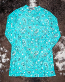 Turquoise paisley print base layer with dark wash jeans and Aztec canvas sneakers flat lay