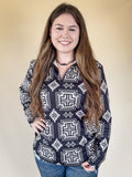 A model posing with one hand on her hip while wearing the Down In The Hills Fitted Pullover in a tan back ground.