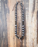 Chunky faux Navajo pearl necklace with oxidized and copper-tone beads shown with ruler for scale.