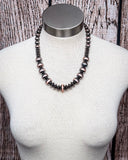 Classic copper and silver beaded faux Navajo pearl necklace displayed on mannequin bust.