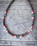 The Chance Navajo Style Pearl & Bead Necklace displayed on metal.