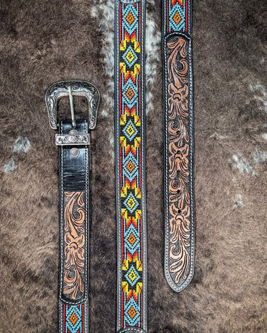 A close-up image of a tooled leather belt with seed bead patterns, showcasing the detailed handcrafted artwork and a silver buckle.