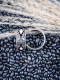 Earrings displayed on wheat and beans.