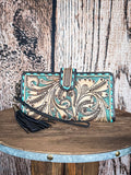 Front view of the Western Swing Wristlet on a wood backdrop.