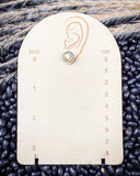 Prairie Petals Stud Fashion Earring on a ruler, displayed on beans and wheat.