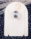 Sky and Stone Stud Fashion Earring on a ruler, displayed on beans and wheat.