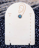 Sky and Stone Stud Fashion Earring on a ruler, displayed on beans and wheat.