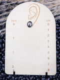Sky and Stone Stud Fashion Earring on a ruler, displayed on beans and wheat.