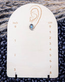 Sky and Stone Stud Fashion Earring on a ruler, displayed on beans and wheat.