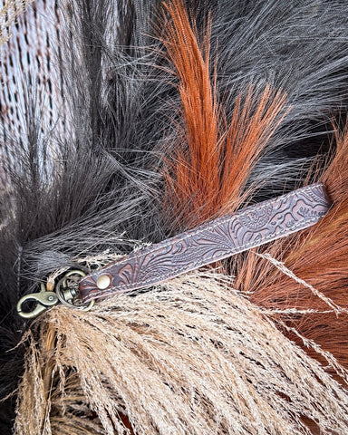 Classic Country Hand-Tooled Key Fob displayed on wheat, wood back drop.