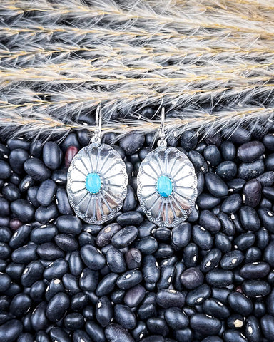 The Abeytu Genuine Turquoise Earrings displayed on beans and wheat.