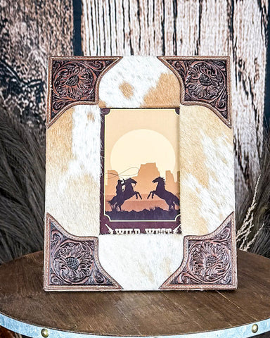 Front view of the Myra Bag - Tumbleweed Trail Photo Frame in Brown and White on a wood background.