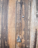 The Lightning Flush Pendant Fashion Necklace displayed on wood background with ruler.