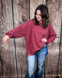 The Stillwater Tunic Top being styled  and modeled by women in front of wooden backdrop.