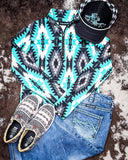 Aztec Everest Fitted Pullover displayed with jeans and shoes on cowhide.