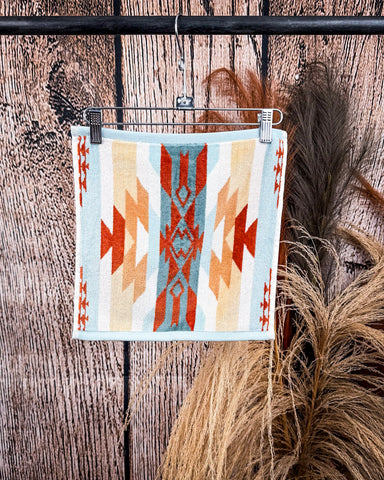 Pecos Towels displayed on rode in front of wood and wheat backdrop.