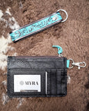 The back of the Pride of Prickly Pears Card Holder, showing the card slots. The wristlet is above it, both displayed on cow hide.