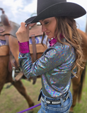 Side view of a model wearing the  Rodeo Voltage Pullover in front of a horse.