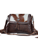 Carved Blossoms Leather & Hairon Bag in a white back drop.