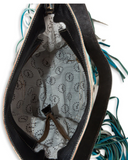 Inside of the Pony Trail Fringed Hand-Tooled Bag in a white back drop.