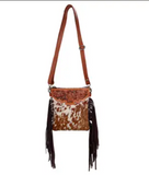 The Roux Hair on Hide Fringe Crossbody Bag in a white back ground.