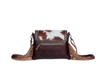 Back view of the Carved Blossoms Leather & Hairon Bag in a white back drop.
