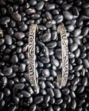 The Folk Tooled Hoop Fashion Earrings displayed on beans.
