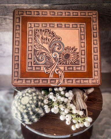 The Myra Bag - Statuesque Jewelry Box displayed on a wooden table with a faux cactus, a plant and a cow skull.