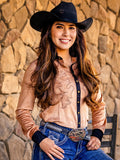 Woman wearing a tan mid-weight stretch suede button up with black trim and western swirl embroidery