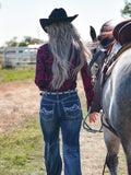 Woman wearing a black long sleeve button up shirt with red paisley print