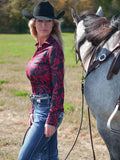 Woman wearing a black long sleeve button up shirt with red paisley print