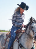 Woman wearing a grayscale chevron print button up shirt.