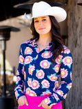 Woman wearing a navy button up shirt with pink and yellow sunflower print