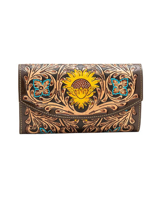 A dark brown tooled leather wallet featuring a large hand-painted yellow sunflower in the center, flanked by turquoise and yellow floral motifs and intricate brown scrollwork.