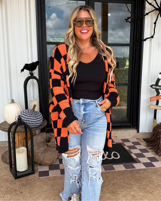 Woman standing in front of a decorated door with Halloween elements