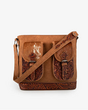 Brown leather crossbody bag with intricate designs on a white background