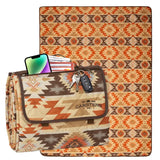 Patterned picnic blanket with a phone, wallet, and keys on top