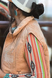 Woman standing in front of a horse wearing a boot stitch vest