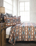 Bed with patterned bedding in a bright bedroom
