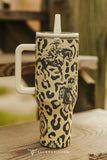 Tribal print tumbler with western cowboy artwork displayed on a table