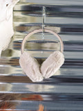 The Aztec Earmuff hanging from a hook that is attached to a metal wall.