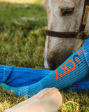 Close up of the Lucky Denim Performance Socks with a horse in the back ground.