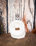 The Aztec Earmuff displayed on a wooden table with a wood back ground.