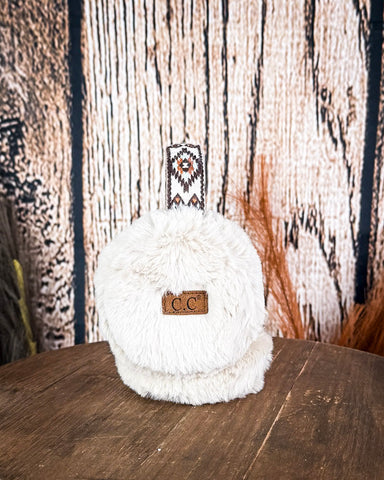 The Aztec Earmuff displayed on a wooden table with a wood back ground.