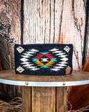 The Aztec Head Wrap displayed on aa wooden table with a wood back ground.